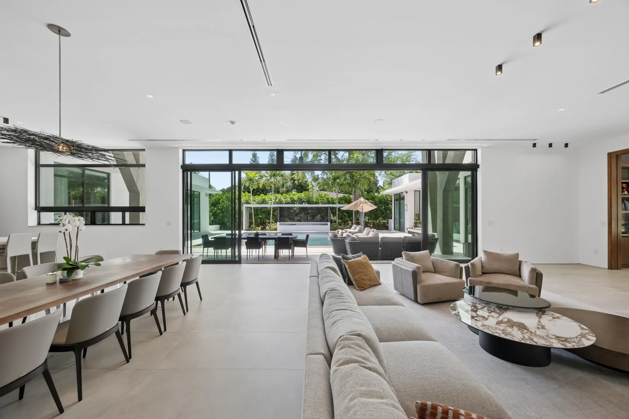 Living room of a Miami Shores estate opening onto the pool deck