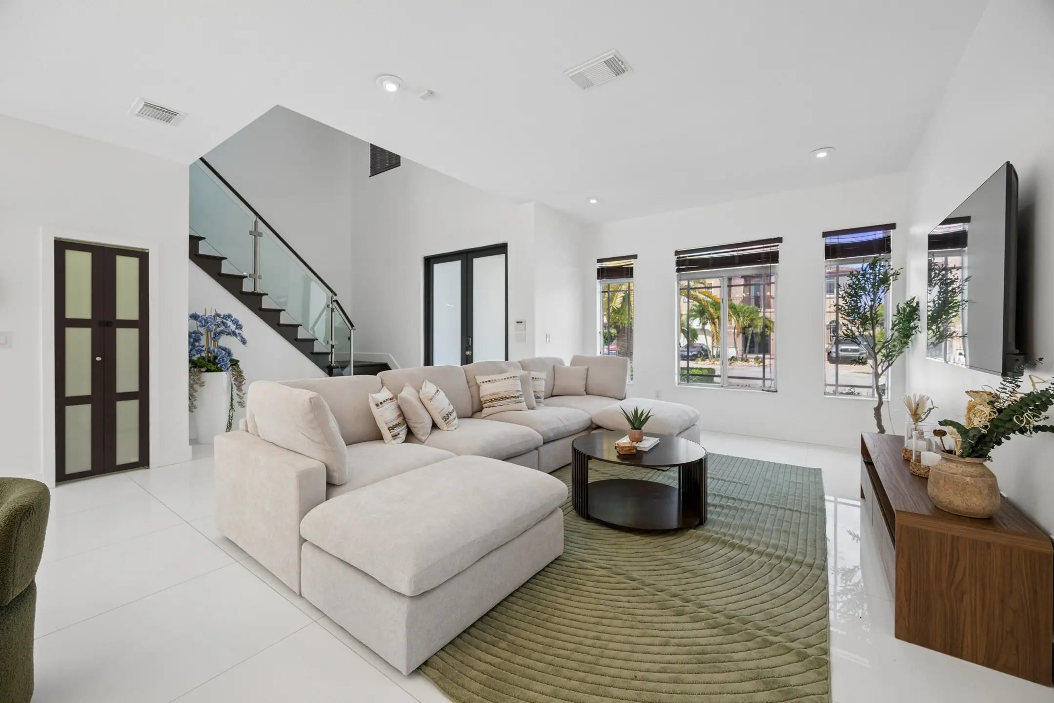 Open-plan living room flowing through to the dining area of a West Kendall home